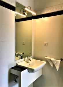a bathroom with a sink and a mirror at Arena Hotel in Beruwala