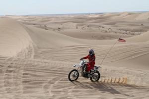 a person riding a motorcycle in the desert at Dry Camping, Bring your own Camping Gear, RV or Mobile, close to sand dunes in Salome