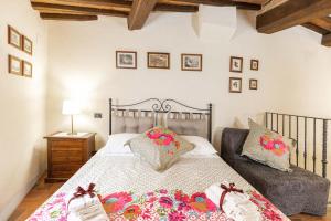 a bedroom with a large bed with pillows on it at La Casina di Rosa in Montepulciano