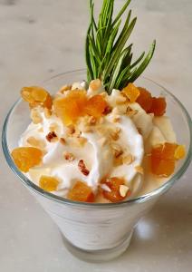 a glass bowl of food with nuts and oranges at Hôtel Restaurant La Chartreuse Logis de France in Cahors