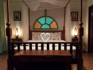 a bedroom with a bed with a heart on it at Baan B&B Sukhothai in Sukhothai