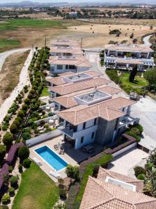 an aerial view of a house with a swimming pool at Atlantis Gardens in Mazotos