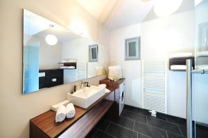 a bathroom with a sink and a mirror at Villa Sasso in Merano