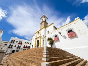 a church with stairs leading up to a building at Brisas del Guadiana in Ayamonte