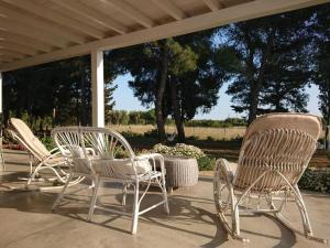 a group of chairs sitting on a porch at LE STELLE DI ARNEO - Casa Vacanze in Torre Lapillo