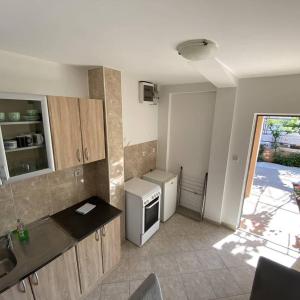 a small kitchen with a sink and a stove at Petkovic Accommodation in Tivat