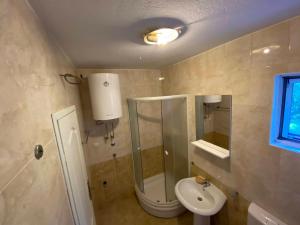a bathroom with a sink and a toilet and a mirror at Petkovic Accommodation in Tivat