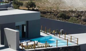 an image of a house with a swimming pool at Melidonia Suites in Akrotiri