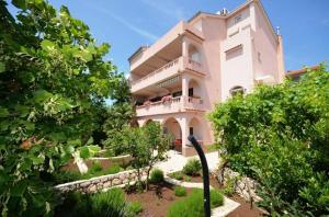 a large white building with people on the balcony at APP St Marin view Novi Vinodolski in Novi Vinodolski