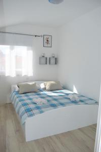 Postel nebo postele na pokoji v ubytování Apartments Janja
