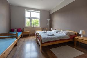 a bedroom with two beds and a window at Pension Vetrny Vrch in Ostrov