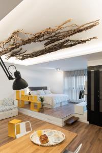 a bedroom with a bed and a table with a plate of food at Suite Nest in Padrón