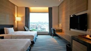 Postel nebo postele na pokoji v ubytování City Suites - Kaohsiung Chenai
