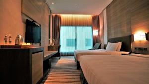 Postel nebo postele na pokoji v ubytování City Suites - Kaohsiung Chenai