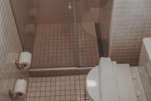 a bathroom with a toilet with two rolls of toilet paper at Samba Rio Convention & Residence in Rio de Janeiro