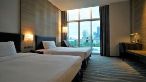 Postel nebo postele na pokoji v ubytování City Suites - Kaohsiung Chenai
