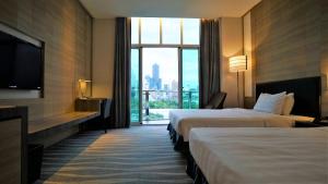 Postel nebo postele na pokoji v ubytování City Suites - Kaohsiung Chenai