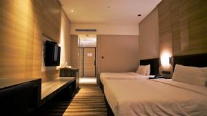 Postel nebo postele na pokoji v ubytování City Suites - Kaohsiung Chenai