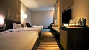 Postel nebo postele na pokoji v ubytování City Suites - Kaohsiung Chenai