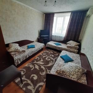 a small room with three beds and a television at Отель in Malyn