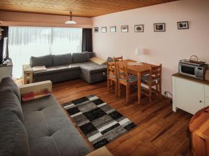 a living room with a couch and a table at Lovely Apartment in Tauplitz