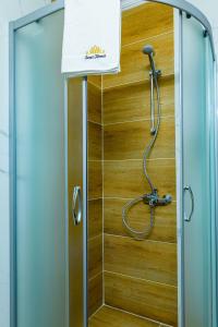 a shower in a bathroom with a glass door at Sweet Homes 6 Apartments in Sunny Beach