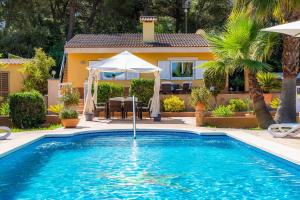 a swimming pool in front of a house at S'oratge in Can Picafort