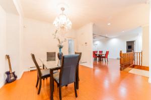 a dining room and living room with a table and chairs at Lee's Place in Surrey