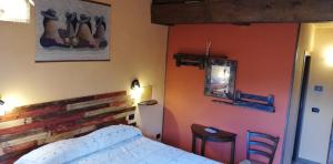 a bedroom with a bed and a wooden wall at B&B Caselunghe in Camerino