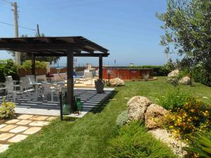a gazebo with a table and chairs in a yard at La casa di Sina in Marsala