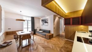 a kitchen and living room with a couch and a table at Apartment Genziana in Ortisei