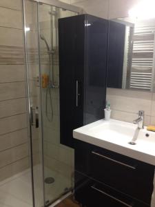 a bathroom with a sink and a shower at Le Cadran So'Lair in Saint-Germain-lʼHerm +8 photos