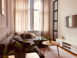 a living room with a couch and a table at ROOM 44 in Osijek