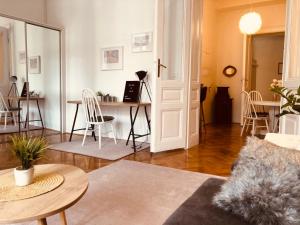 a living room with a table and chairs at ROOM 44 in Osijek
