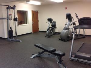 a gym with several exercise bikes and tread machines at Richland Inn and Suites in Sidney