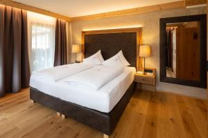 Łóżko lub łóżka w pokoju w obiekcie Olympia-Relax-Hotel Leonhard Stock