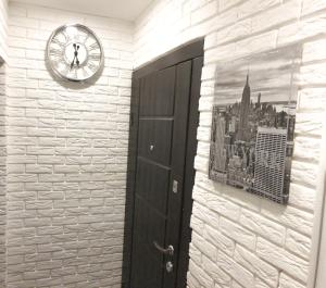 un reloj en una pared al lado de una puerta en Apartment Studio New York 92, en Irpín