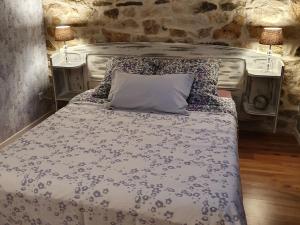 a bed in a room with two night stands and two lamps at Graine de Reves in Saint-Sauveur-la-Pommeraye