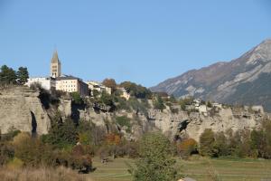 a building on the side of a mountain at Le Vieux Chalet in Embrun