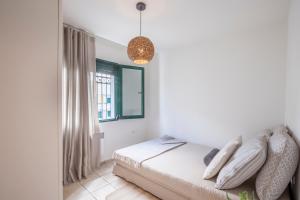 A bed or beds in a room at Acroyali Beach House