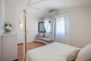 A bed or beds in a room at Acroyali Beach House