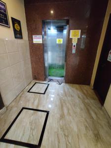 a hallway with two mats on the floor of a building at Hotel Savi Regency in Jaipur