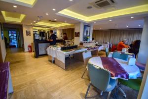 a restaurant with tables and chairs and people in it at City Hotel Marmaris in Marmaris