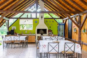a dining room with tables and chairs in a barn at Pensiunea Sanziana in Gura Rîului