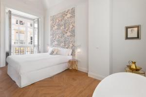 A bed or beds in a room at Be Mate Málaga Centro