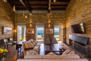 a living room with a brick wall at Villa Ionica in Kontokali
