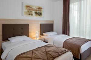 a hotel room with two beds and a window at The Room Hotel & Apartments in Antalya