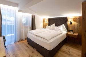 Łóżko lub łóżka w pokoju w obiekcie Olympia-Relax-Hotel Leonhard Stock