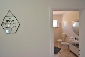 a bathroom with a sign that reads is your own kind beautiful at Apartman Fuma in Rovinj