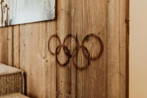 a wooden wall with the olympics sign on it at Olympia-Relax-Hotel Leonhard Stock in Finkenberg